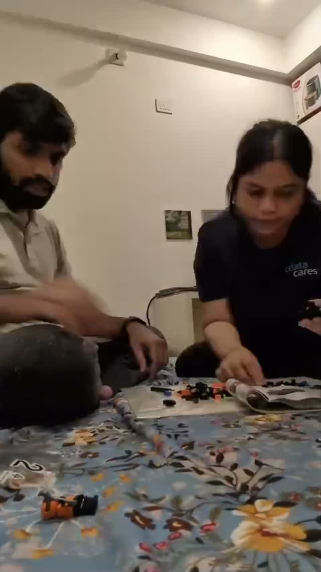 Yazhini and Rahul building with little bricks together
