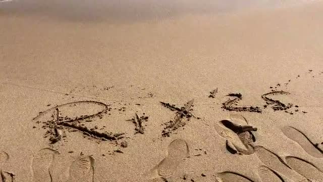 R plus Y written in the sand